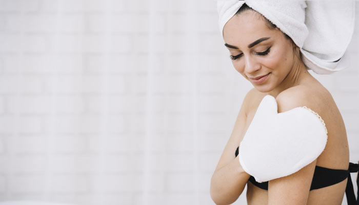 Women Scrubbing Her Arms | Benefits of Exfoliating Skin