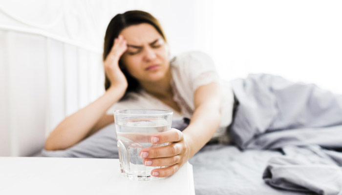 Woman Experiencing Hangover Headache | Alcohol Abuse and Hangover