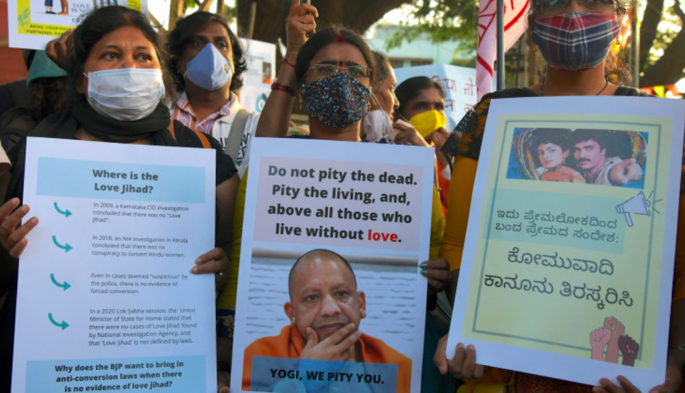 Protestors Holding Banners of BJP Member and Uttar Pradesh CM Yogi Adityanath