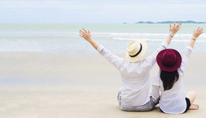 Two Friends Sitting On A Beach | Zodiac Signs Travel Buddies Personality